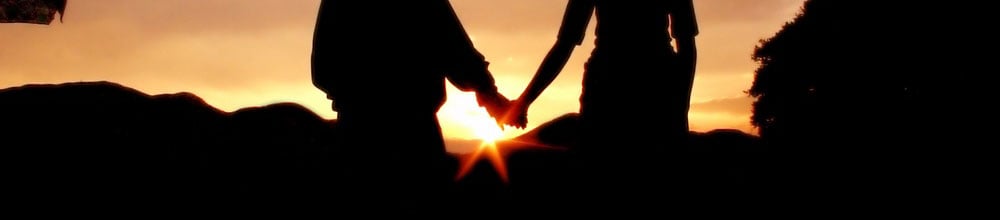 couple-of-teenagers-holding-hands-in-front-of-a-sunset-in-the-andes_crop